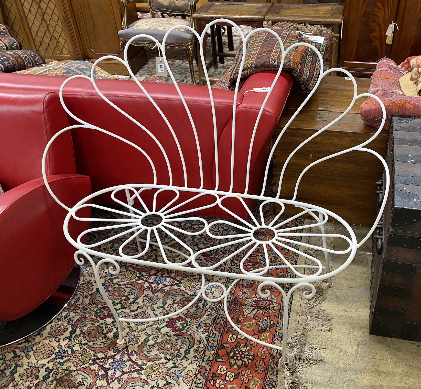 A painted wrought iron garden bench, length 113cm, depth 46cm, height 102cm